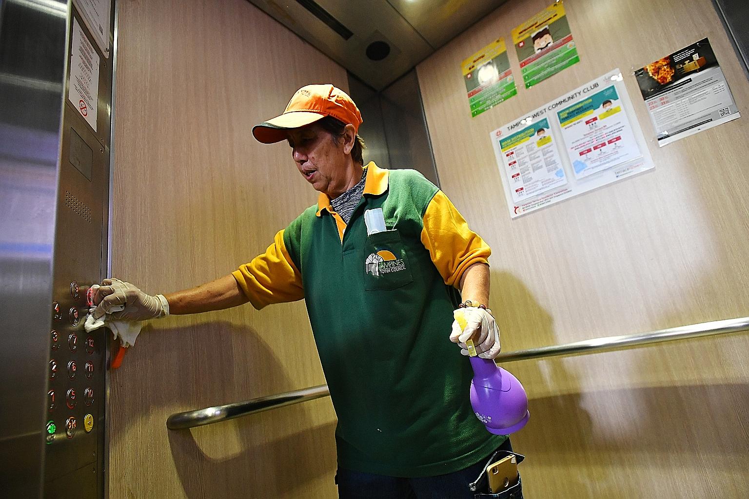 A lift being cleaned thoroughly at a block in Tampines. Using a pen or tissue to press the lift button is one of the precautionary measures suggested.