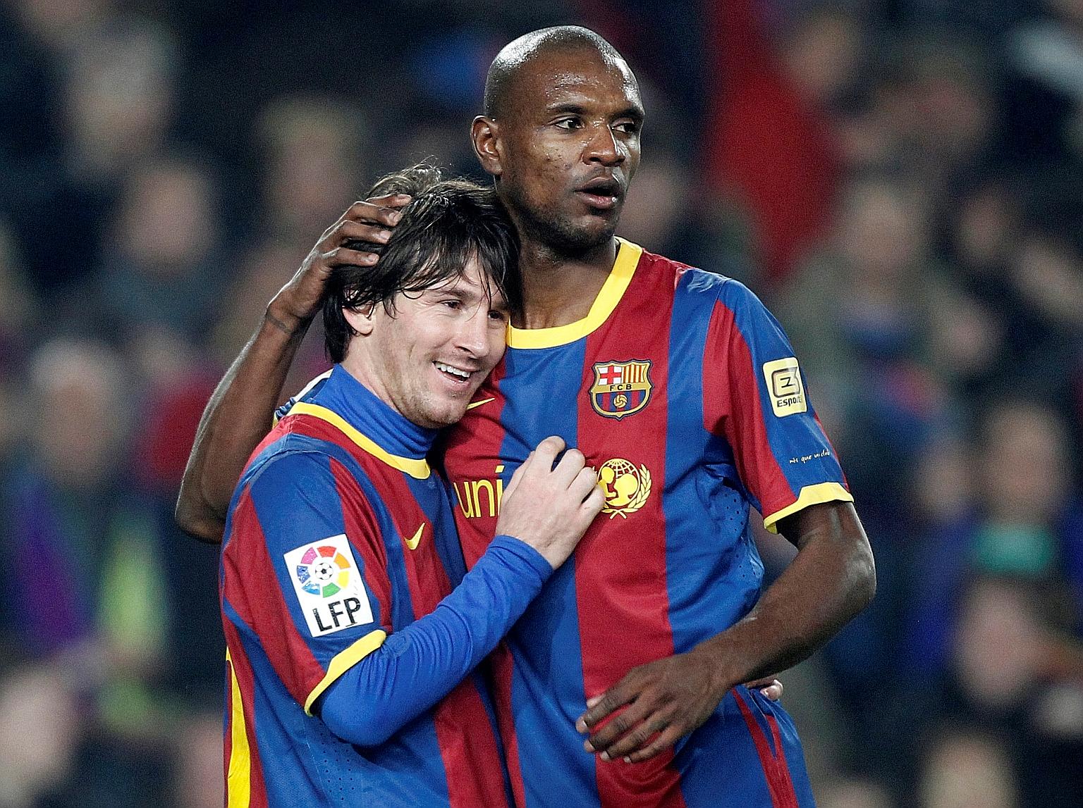Eric Abidal congratulating Lionel Messi after his goal for Barcelona in a La Liga game against Atletico Madrid in February 2011. They played together for six years but appeared to have fallen out over the recent coaching change and tensions between p