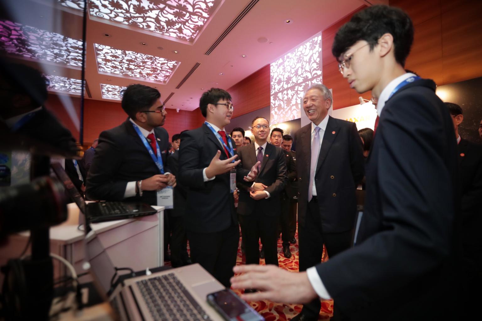 Ashwin Dinesh among Singapore Polytechnic students speaking with Senior Minister Teo Chee Hean at the Global Space and Technology Convention