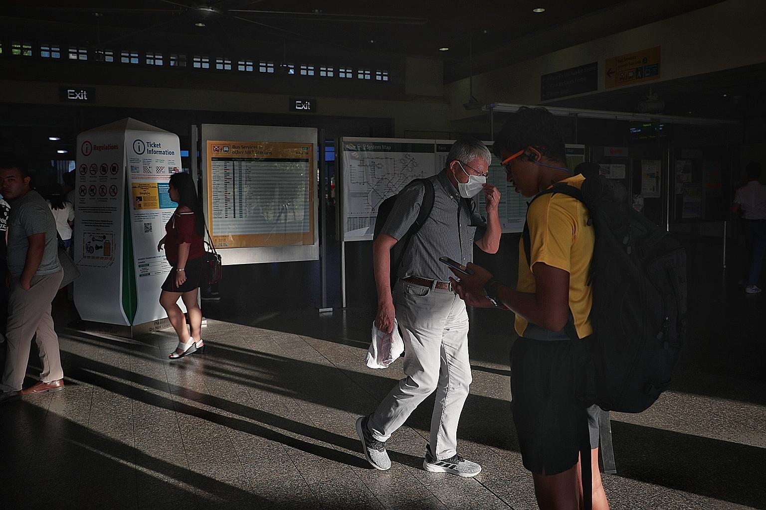 A commuter wearing a mask at Pasir Ris MRT station yesterday. The Health Ministry has continued to advise those who are unwell to stay home. If they must go out, they should wear a mask and avoid coming into close and sustained proximity with others.