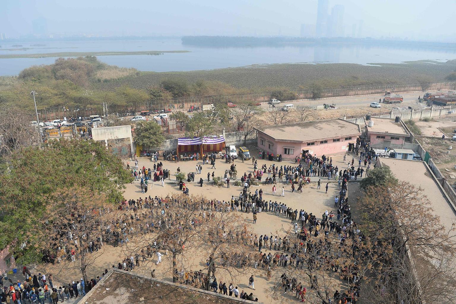 People queueing at a polling station to cast their votes during the state election in Delhi yesterday.
