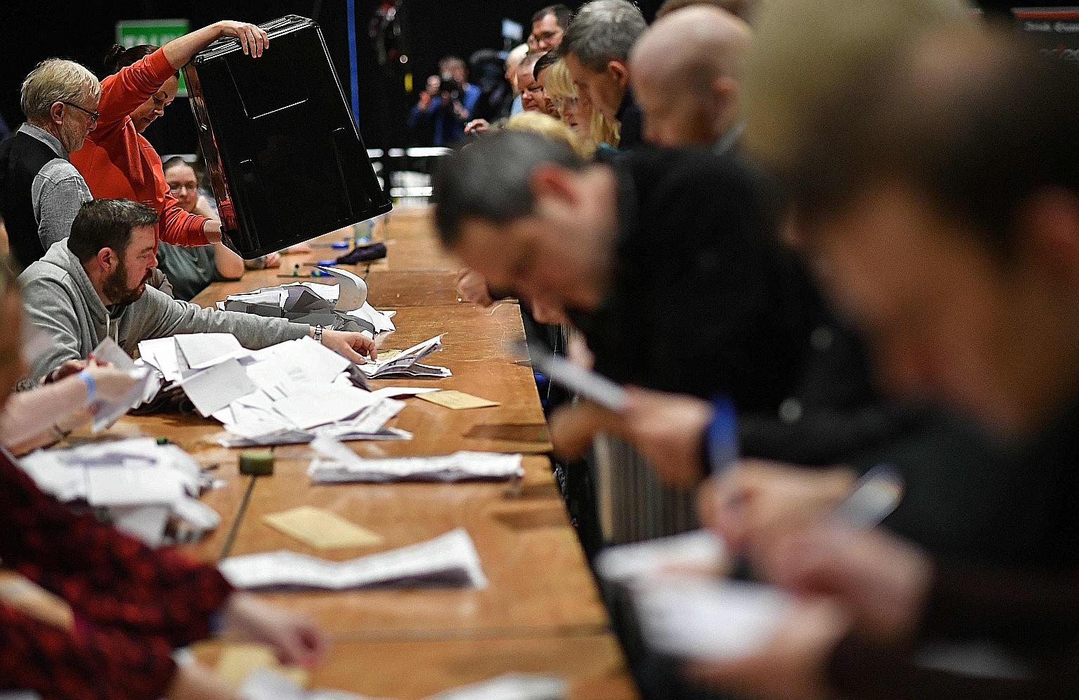 Vote counting under way for the Irish elections at the Dublin City count centre, in the RDS centre, in Ireland yesterday. An exit poll showed the nation's three biggest political parties in a dead heat.