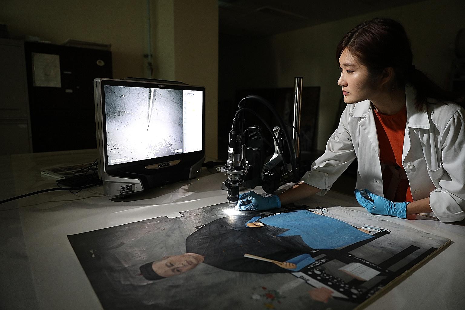Conservation scientist Lynn Chua, 34, using a 3D digital microscope to examine a late 19th to early 20th century oil-based portrait of Mr Tan Beng Wan, the eldest son of Mr Tan Kim Tian. The pair had founded Tan Kim Tian and Son Steamship Company in