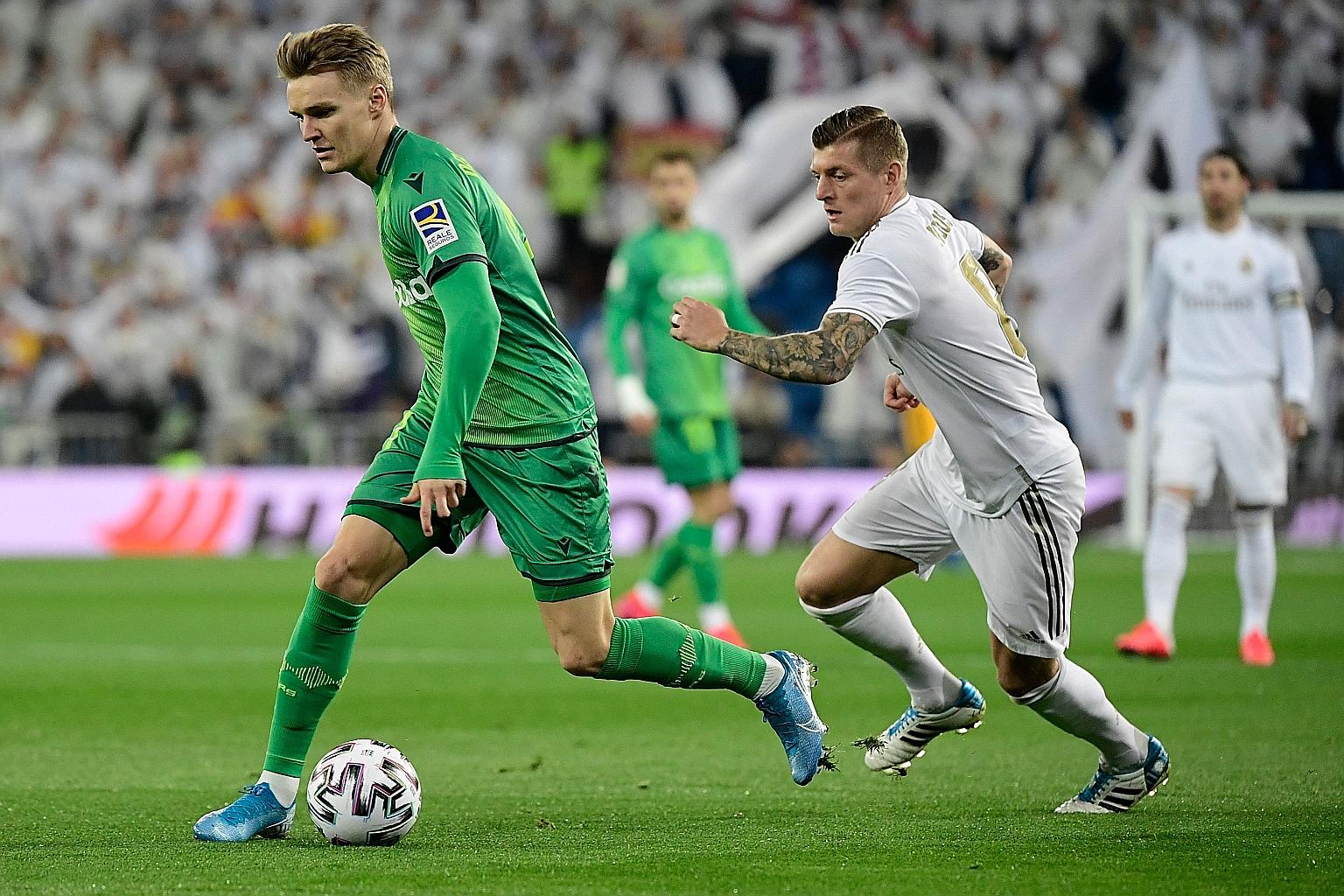 Real Sociedad midfielder Martin Odegaard (left, chased by Real Madrid's Toni Kroos) was among the scorers in his team's 4-3 King's Cup quarter-final win last week. PHOTO: AGENCE FRANCE-PRESSE