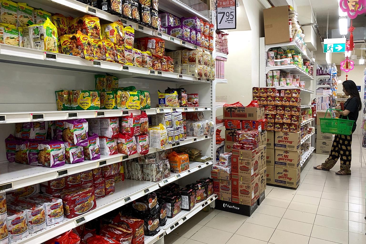 Shelves packed with instant noodles at a FairPrice outlet near Braddell Road yesterday. Singapore has over 40 fresh and instant noodle manufacturers, and some have upped supply. ST PHOTO: KUA CHEE SIONG