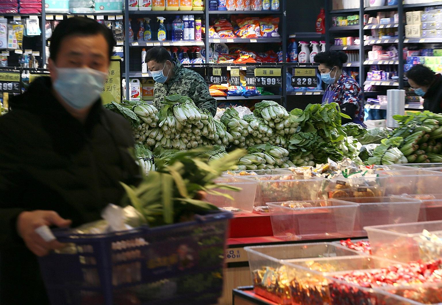 Shoppers at a food store in Wuhan, in China's Hubei province. Epidemiologist Ian Lipkin believes there is a chance that, by mass quarantining individuals, healthy patients could have come into contact with those who are infected but asymptomatic, whi