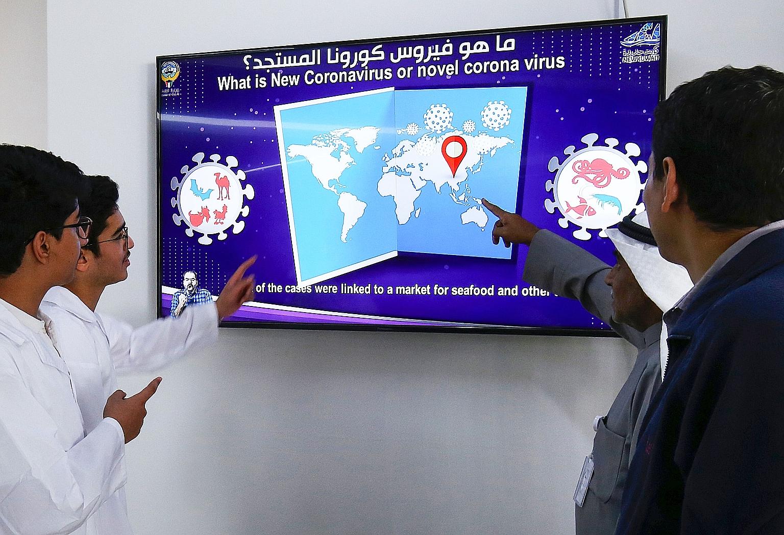 Kuwaiti students watching a video on coronavirus infection. The country has issued an advisory against travel to Singapore. PHOTO: AGENCE FRANCE-PRESSE