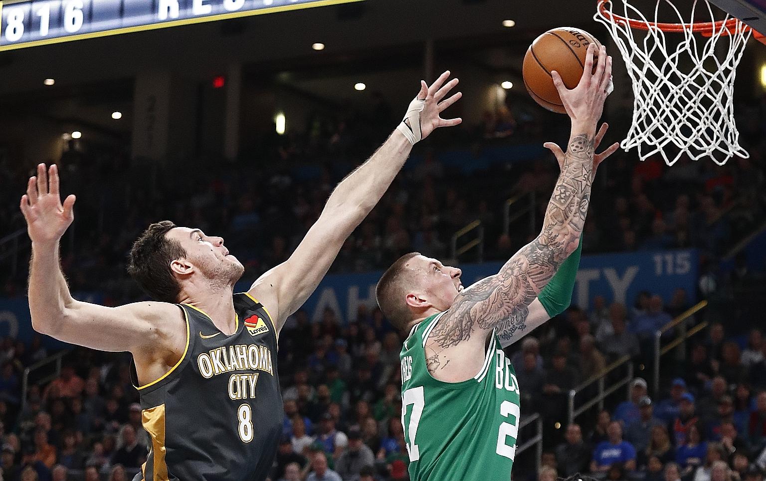 Boston starter Gordon Hayward sinking two of his 13 points of the night past Oklahoma City's Danilo Gallinari during their NBA game at Chesapeake Energy Arena on Sunday. Celtics extended their winning streak to seven games after the 112-111 triumph.
