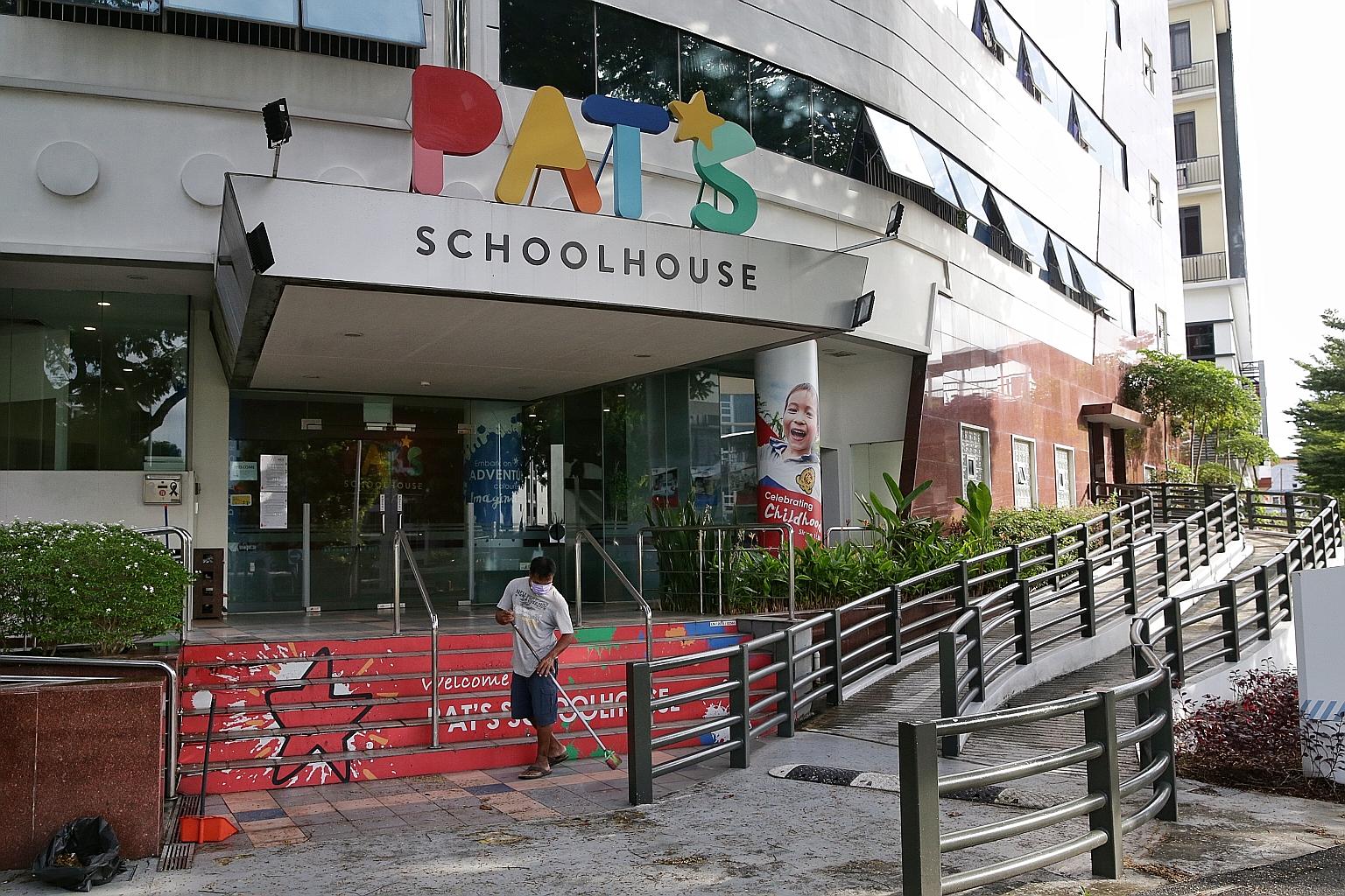 Above: A worker sweeping outside the entrance of Pat's Schoolhouse Kovan yesterday. One in 10 children attending the pre-school, which is linked to a new coronavirus case, turned up for school yesterday. ST PHOTO: KEVIN LIM Left: Education Minister O