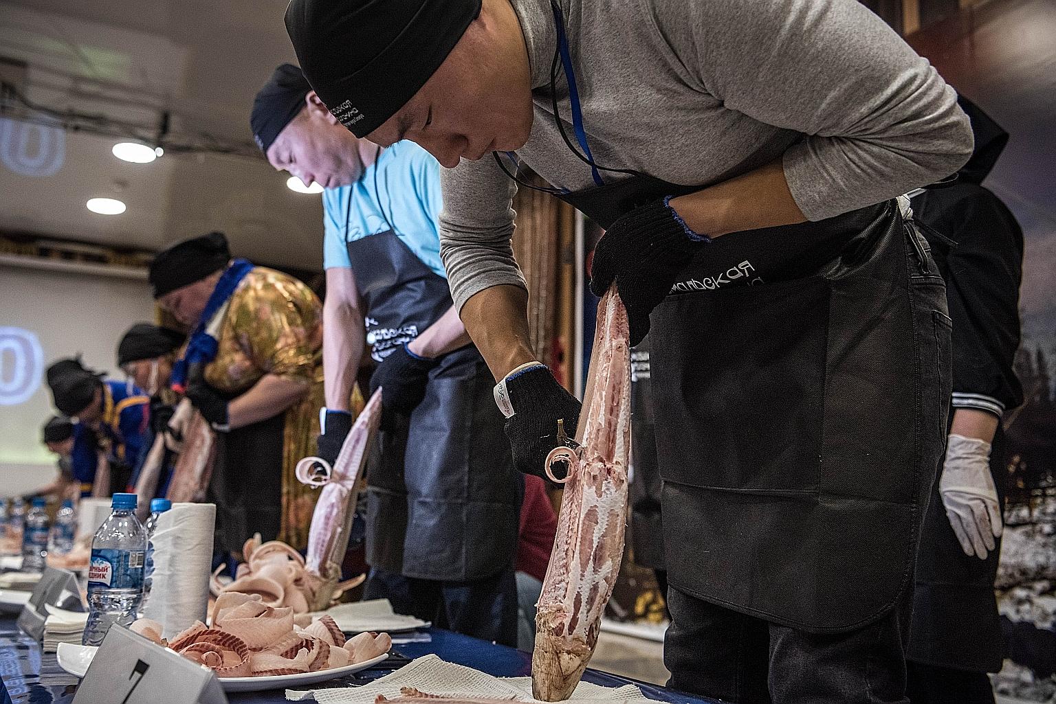 Competitors slicing stroganina during a festival in Yar-Sale, Russia, last December.
