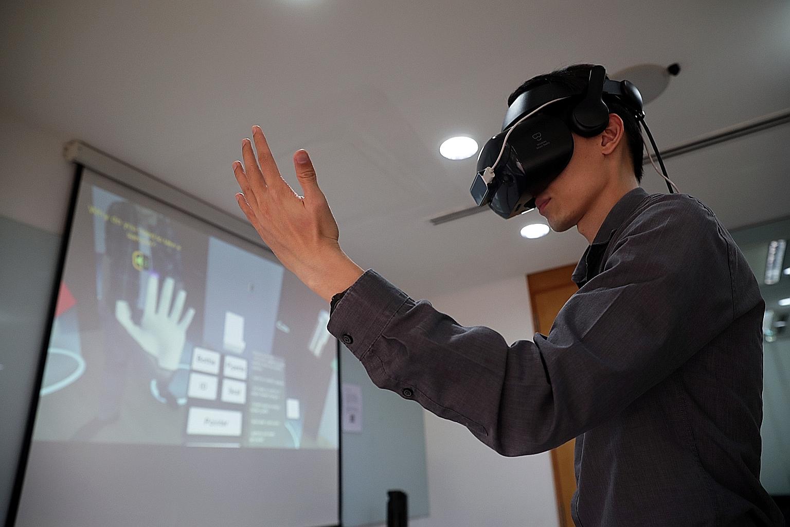 Mr Aaron Ng, a senior executive at NEA's Vector Control Section, demonstrating the use of VR gear in a dengue home inspection scenario. He said the virtual reality training module would help officers experience more scenarios and hone their reaction 