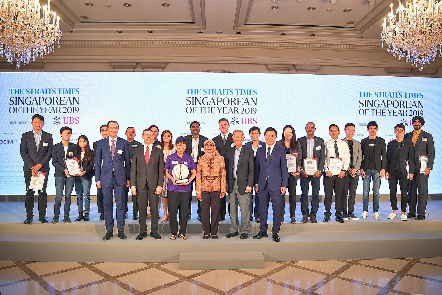 President Halimah Yacob with (front row, from left) Mr August Hatecke, country head for Singapore and co-head of global wealth management for Asia-Pacific at UBS; Mr Warren Fernandez, editor-in-chief of Singapore Press Holdings' (SPH) English/Malay/T