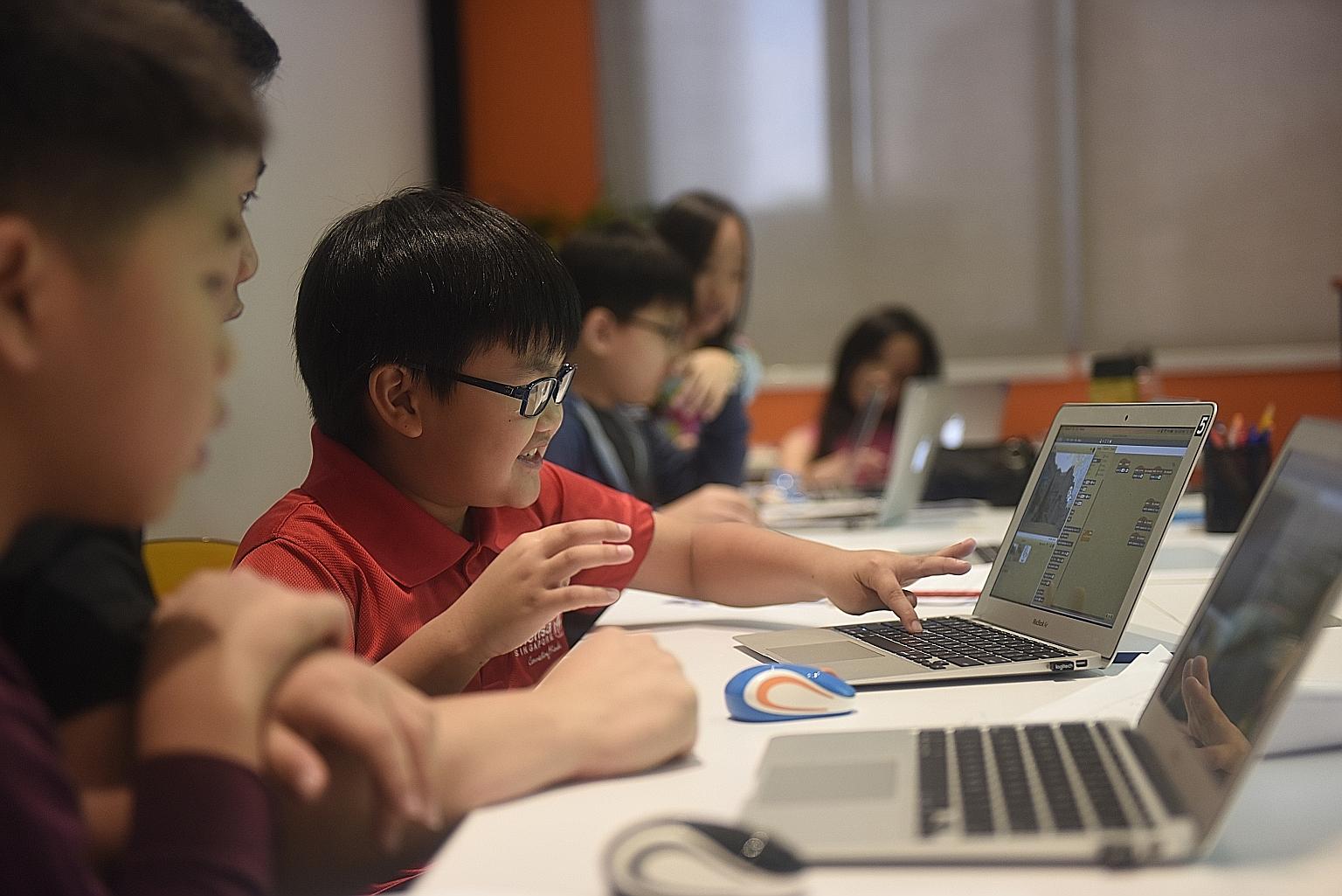 Children in Singapore learning how to build computer programs at a coding class. Dr Yuhyun Park, founder of the DQ Institute, said children around the world are consistently being exposed to serious risks online and a lot more must be done to help th