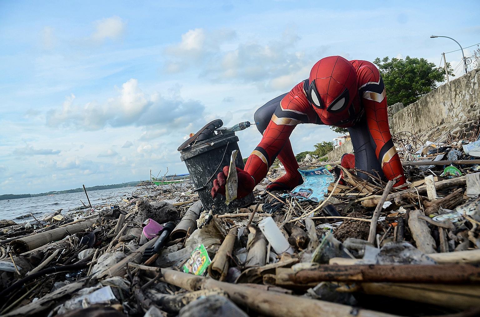 "Spider-Man" Rudi Hartono channelling a famous quote in the superhero's comics - with great power comes great responsibility - by collecting rubbish at a beach in Pare-Pare, South Sulawesi. Before he hit on the idea of wearing the costume, he did not