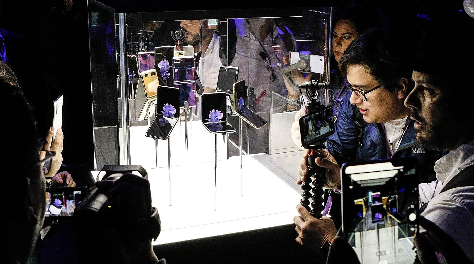Samsung's Galaxy Z Flip folding smartphone on display in San Francisco, California, on Tuesday. Its clamshell design is a departure from the electronics maker's first foldable phone, the Galaxy Fold, launched last September. PHOTO: AGENCE FRANCE-PRES