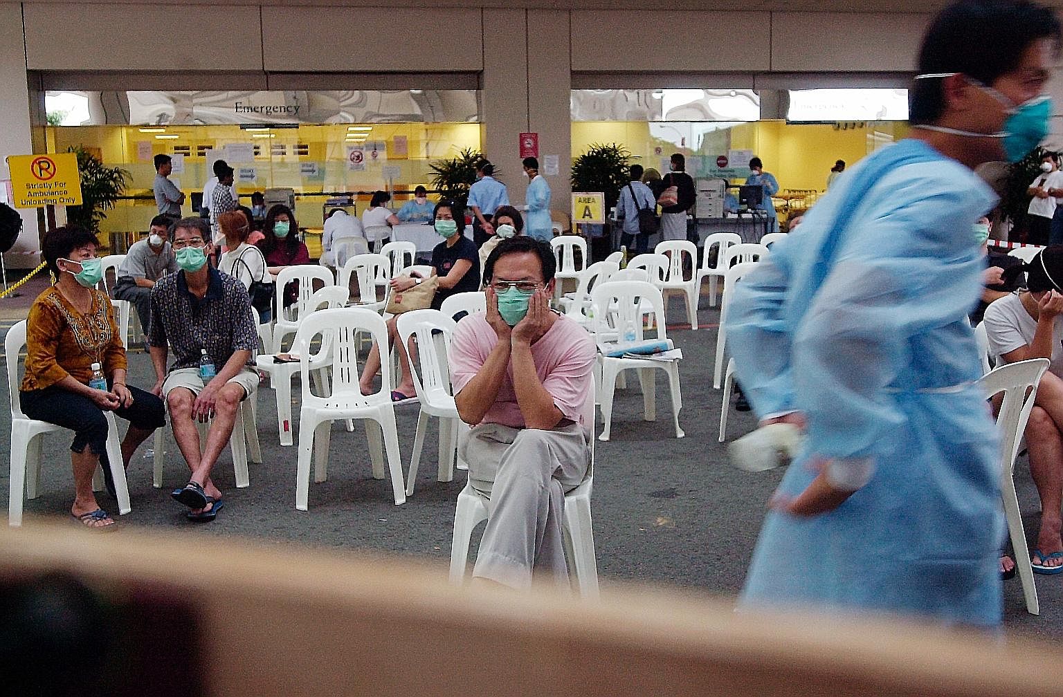 Patients waiting to be screened for the severe acute respiratory syndrome outside Tan Tock Seng Hospital's accident and emergency department during the outbreak. The writer points out that during the Sars crisis in 2003, the people of Singapore behav
