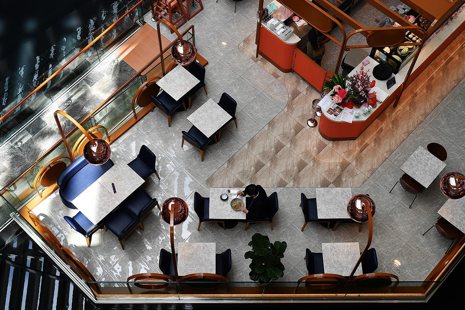 A lone customer at a cafe at The Shoppes at Marina Bay Sands. National University of Singapore Business School associate professor Lawrence Loh expects the impact of the coronavirus outbreak here will be addressed with a one-off and targeted Budget b