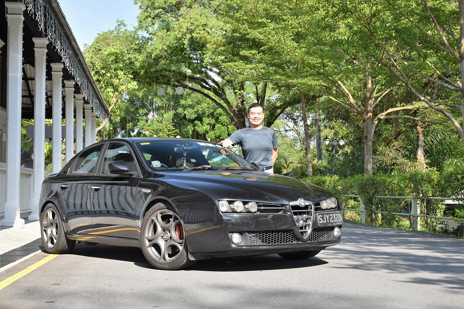 Property agent Elgin Lim, 46, with his Alfa Romeo 159. He says he is keeping his car beyond 10 years because he enjoys driving it, and it is economical to do so.