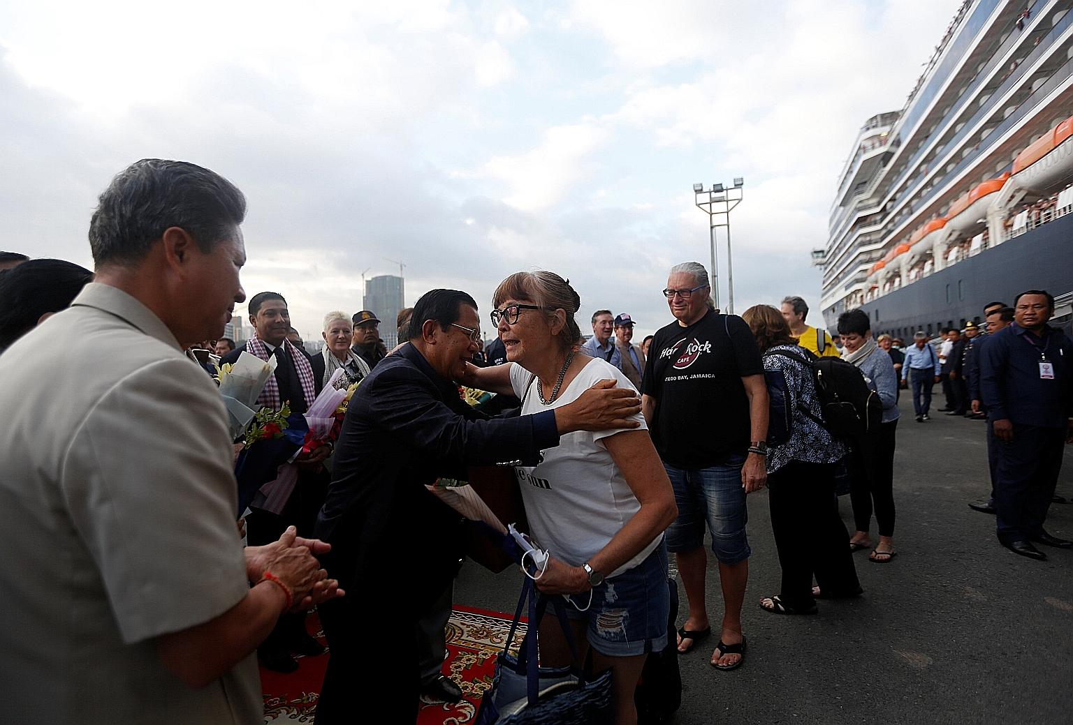 Cambodia's Prime Minister Hun Sen yesterday welcoming a passenger of the MS Westerdam, a cruise ship that had spent two weeks at sea after being turned away by five places over coronavirus fears. The ship had set sail from Hong Kong on Feb 1. Over in