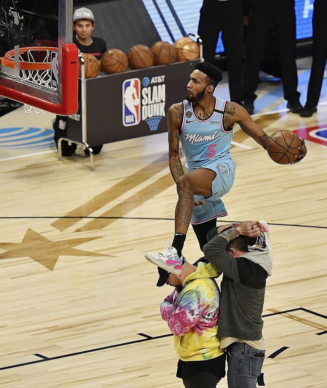 Miami's Derrick Jones Jr leaping over two "props" in the slam dunk contest during the All-Star Saturday Night at the United Centre. He beat Orlando's Aaron Gordon.