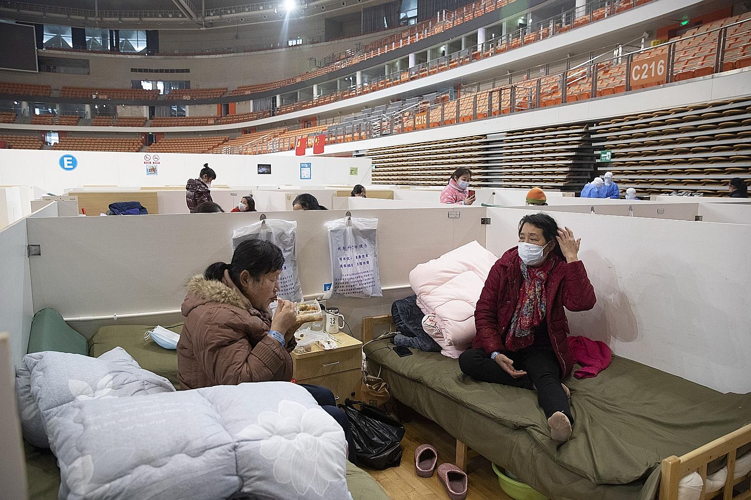 Patients at Wuhan Fangcang hospital, a makeshift hospital to treat coronavirus patients, in Wuhan city in China's Hubei province last Friday. The National Health Commission yesterday reported 2,009 new cases, down from 2,641 the previous day. PHOTO: