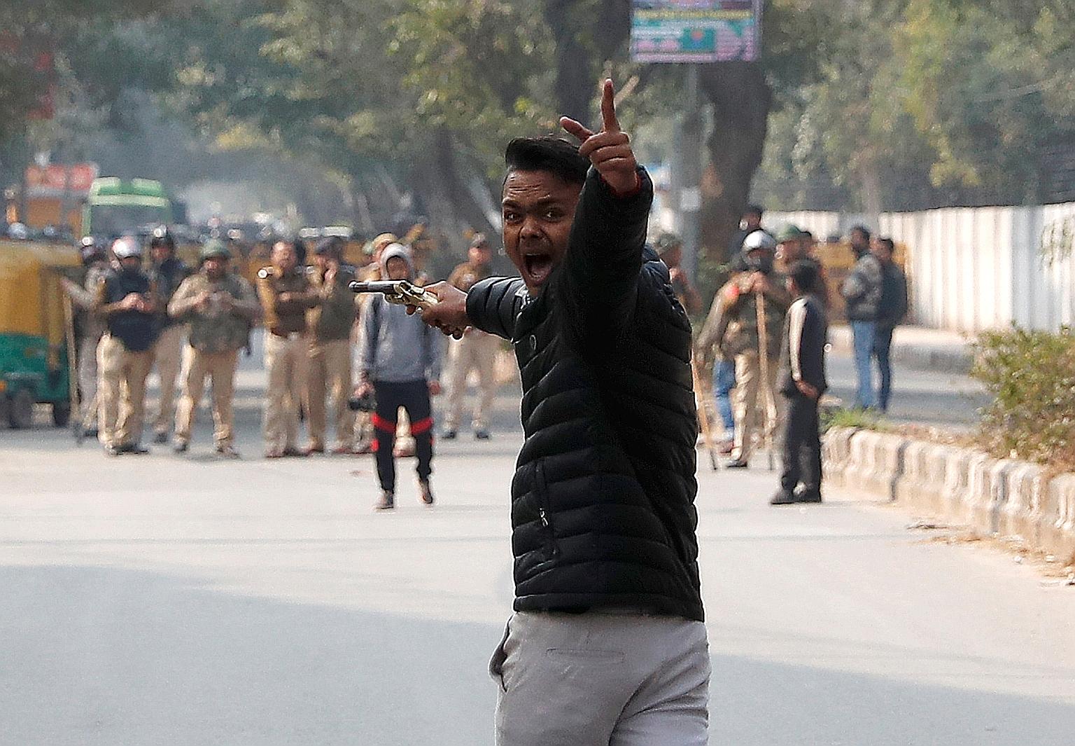 An unidentified teenager brandishing a gun during a protest on Jan 30 against a new citizenship law outside the Jamia Millia Islamia university in New Delhi, India.