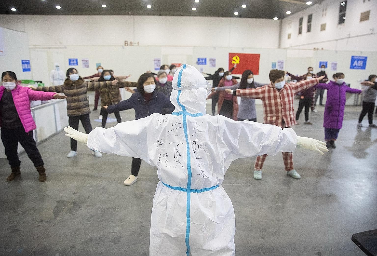Patients exercising with medical staff inside the Wuhan Fang Cang makeshift hospital in Wuhan on Monday.