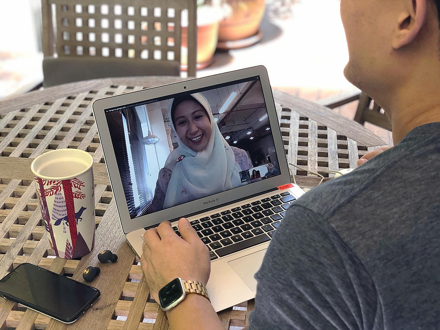 Ms Athirah Khairunnisa (on laptop screen), an account manager at Splash Productions, conducting a video conference call with her colleagues who are based at separate worksites. The marketing communications company split its staff into two teams a wee