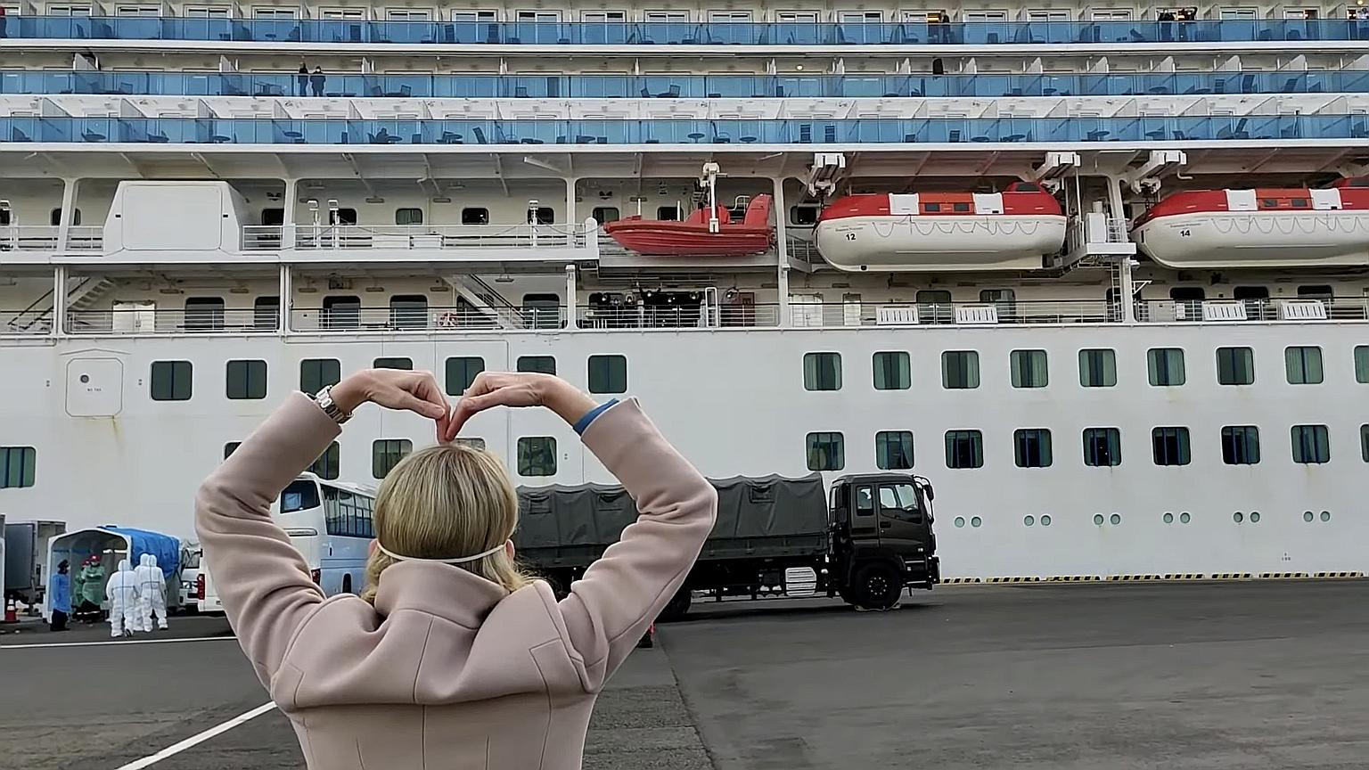Princess Cruises president Jan Swartz gesturing towards the Diamond Princess liner at the dock in Yokohama, as passengers disembarked yesterday after two weeks of quarantine.