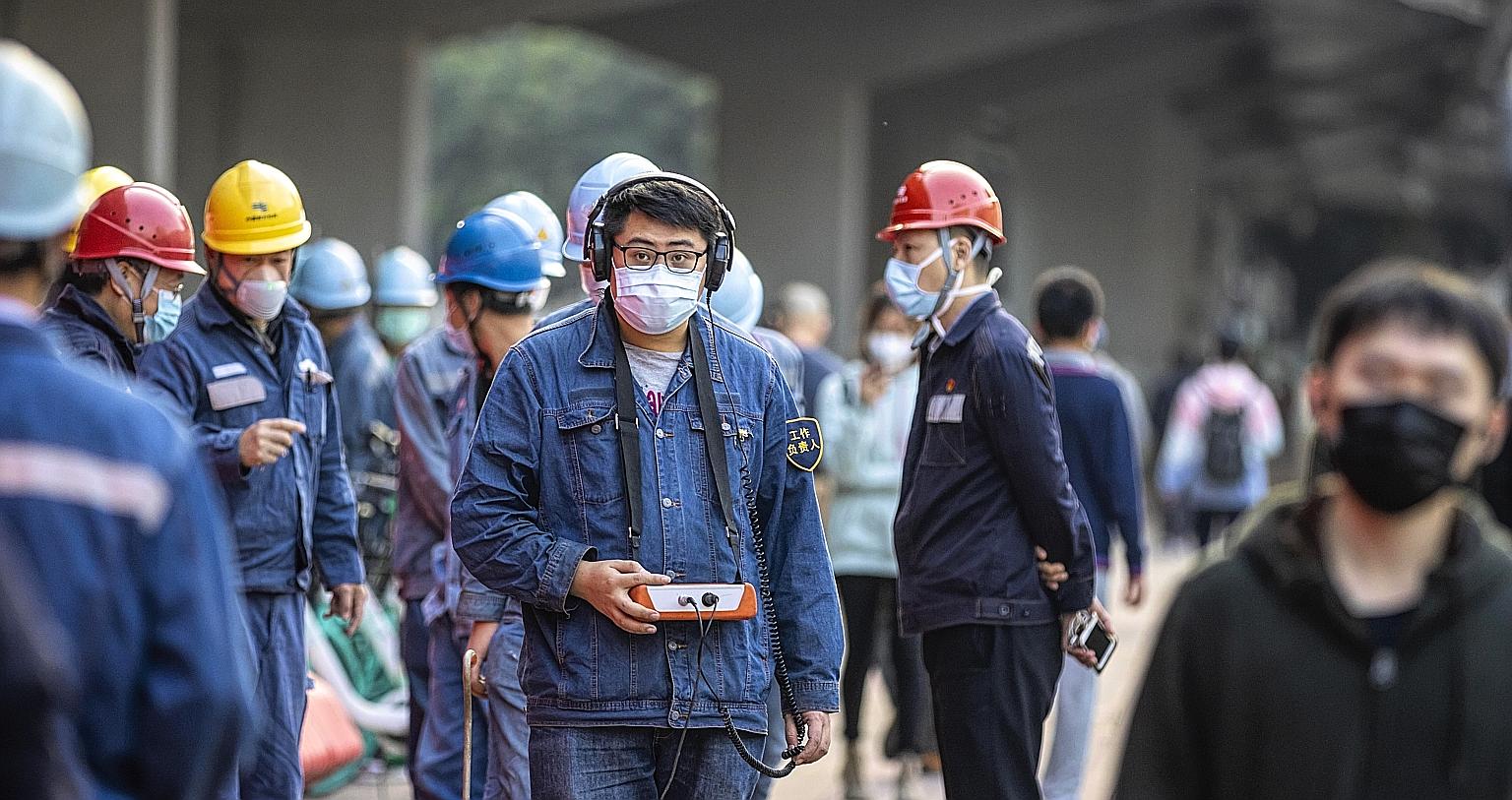 Workers wearing masks in Guangzhou. The coronavirus outbreak has resulted in the temporary closure of some businesses in China.