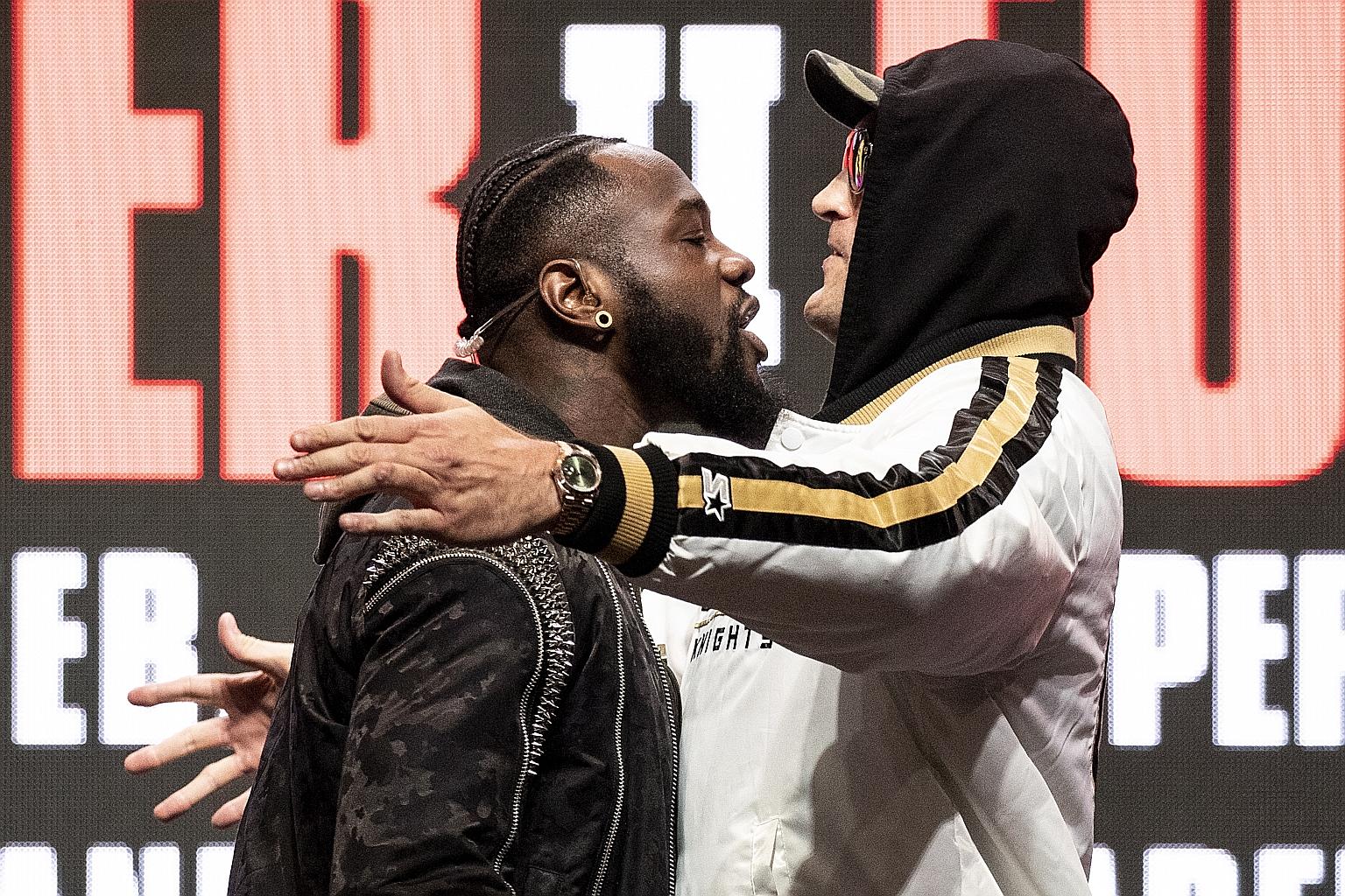 American Deontay Wilder and Briton Tyson Fury facing off on stage during their last press conference on Wednesday ahead of today's rematch for the WBC heavyweight world championship in Las Vegas, Nevada. After exchanging shoves, they hurled insults a