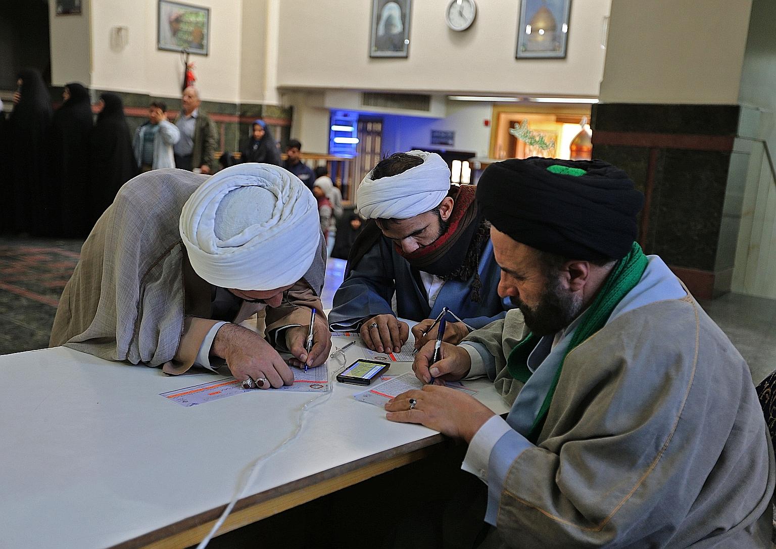 Iranians casting their votes at the Shah Abdul Azim shrine in Teheran yesterday. President Hassan Rouhani has urged his people to demonstrate "victory" by voting in large numbers.