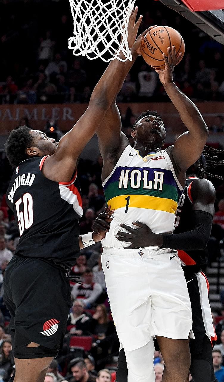New Orleans Pelicans' Zion Williamson is fouled by Portland Trail Blazers' Wenyen Gabriel (No. 35) as Caleb Swanigan closes in during the second quarter at Moda Centre. Williamson had a team-high 25 points in New Orleans' 128-115 victory. PHOTO: REUT