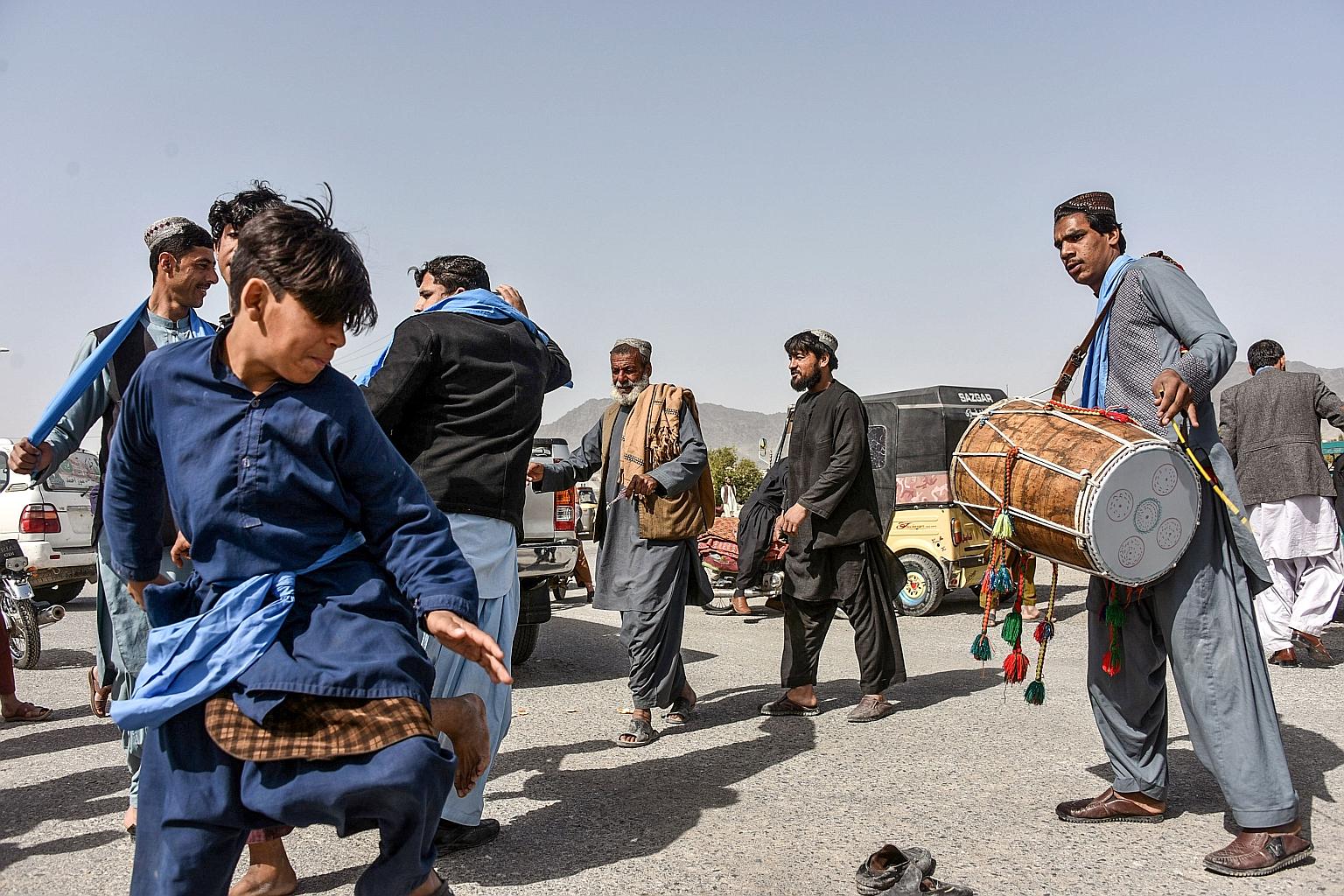 People dancing as they celebrated the first day of the week-long truce in Afghanistan's Kandahar province yesterday. The Taleban, US and Afghan forces agreed to the "reduction in violence" which, if it holds, will be only the second lull in fighting 
