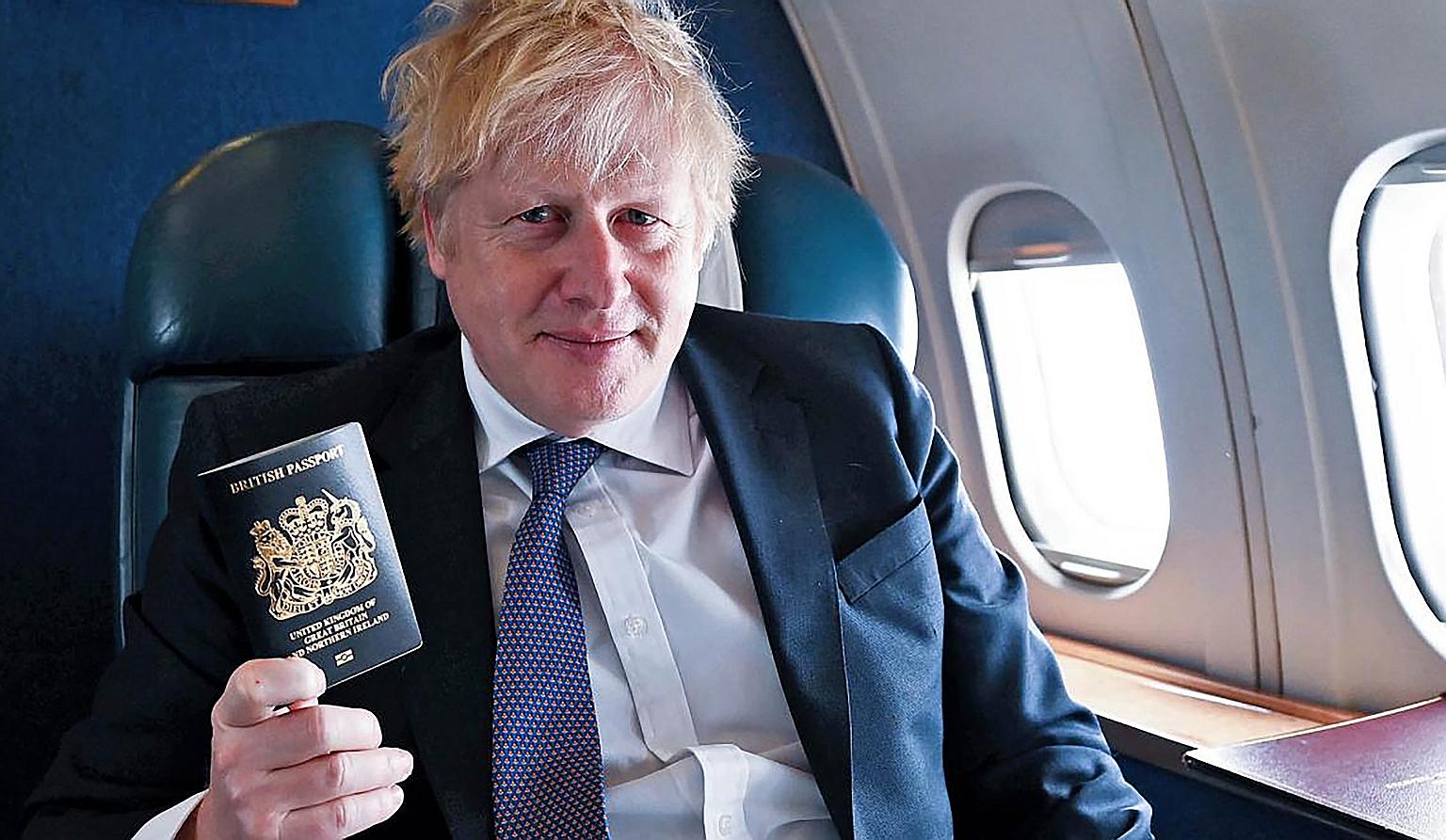 Prime Minister Boris Johnson with the new British passport. The new blue passports, being made in Poland, will replace the burgundy passports introduced in 1988. PHOTO: 10 DOWNING STREET