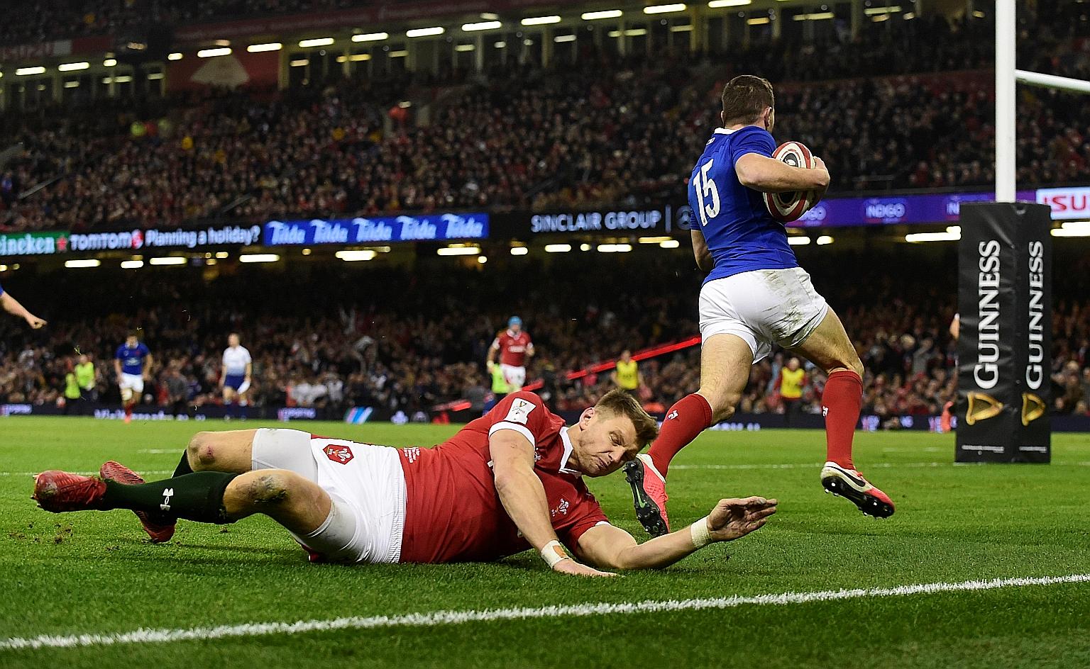Anthony Bouthier scoring France's first try in their 27-23 win. The visitors held firm against Wales' second-half fightback to stay top of the Six Nations standings with three wins.