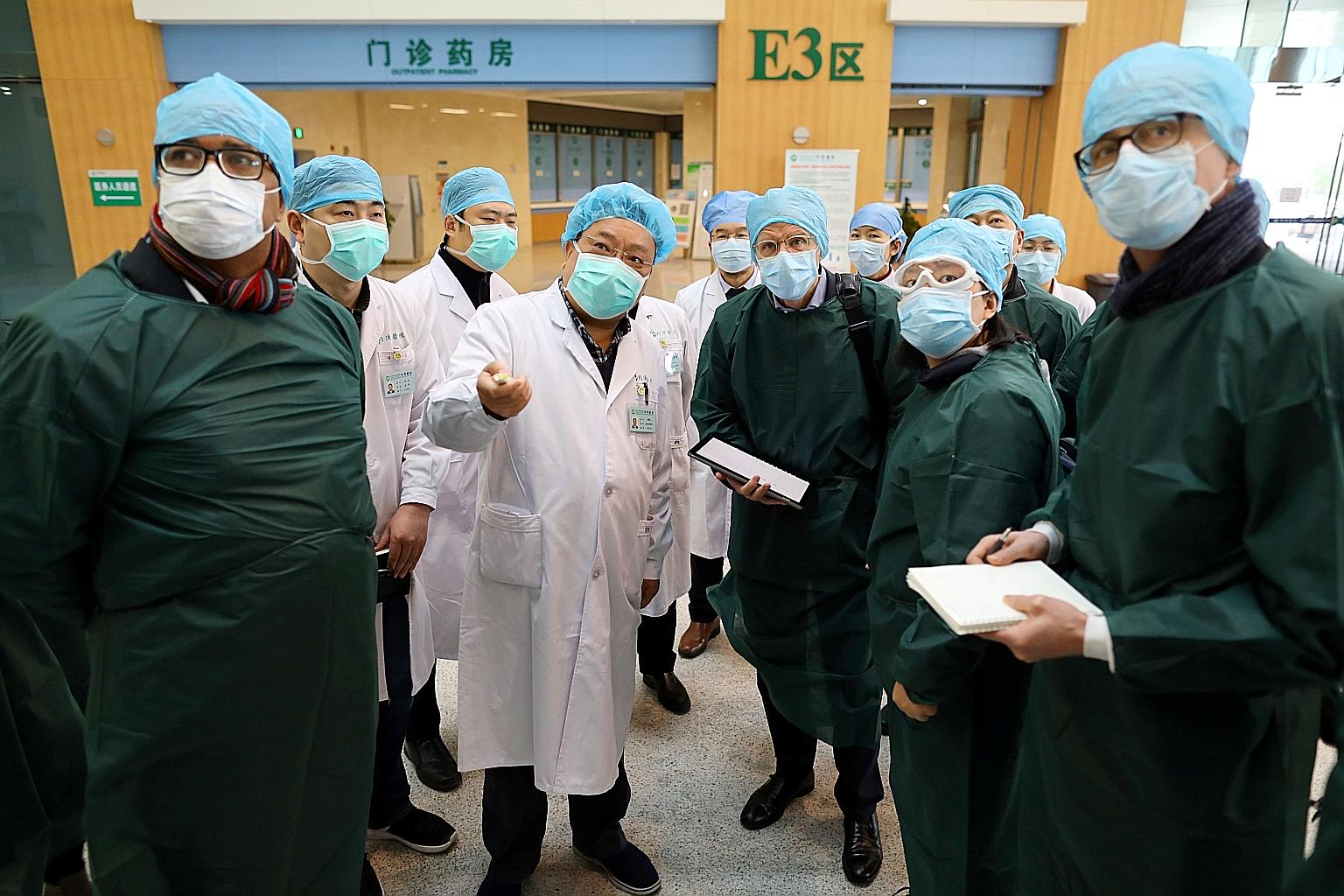 Experts from China and the World Health Organisation visiting the Wuhan Tongji Hospital in Hubei province yesterday. Chinese President Xi Jinping said it is necessary to learn from "obvious shortcomings exposed" during China's response, - a rare ackn