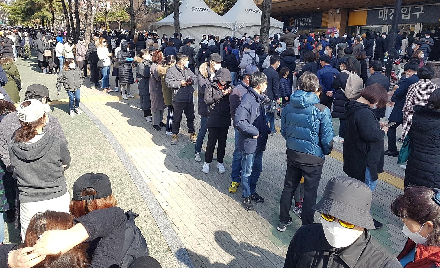 People waiting to buy masks at a market in Daegu, South Korea, yesterday. South Korea has raised its virus alert to the highest red as the number of cases continues to spike, hitting 833 yesterday, with more than half linked to a cluster of infection