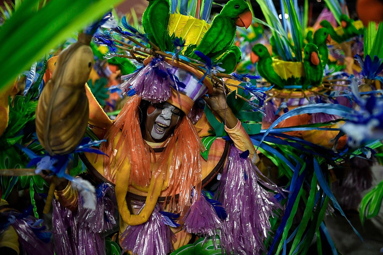 A member of the Grande Rio samba school performing on the first night of the Rio Carnival parade at the Sambadrome in Rio de Janeiro, Brazil, on Sunday. At the event, several schools face off in a competition before tens of thousands of people, as fo