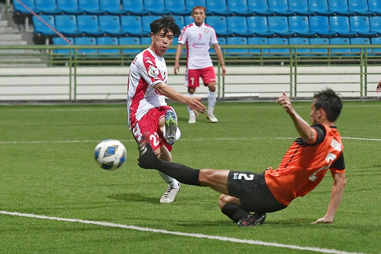 Ho Chi Minh City forward Nguyen Cong Phuong getting off a shot as Hougang United defender Anders Aplin tries to block. Singapore Premier League side Hougang lost the AFC Cup Group F match 3-2 at Jalan Besar Stadium yesterday despite a late brace by S