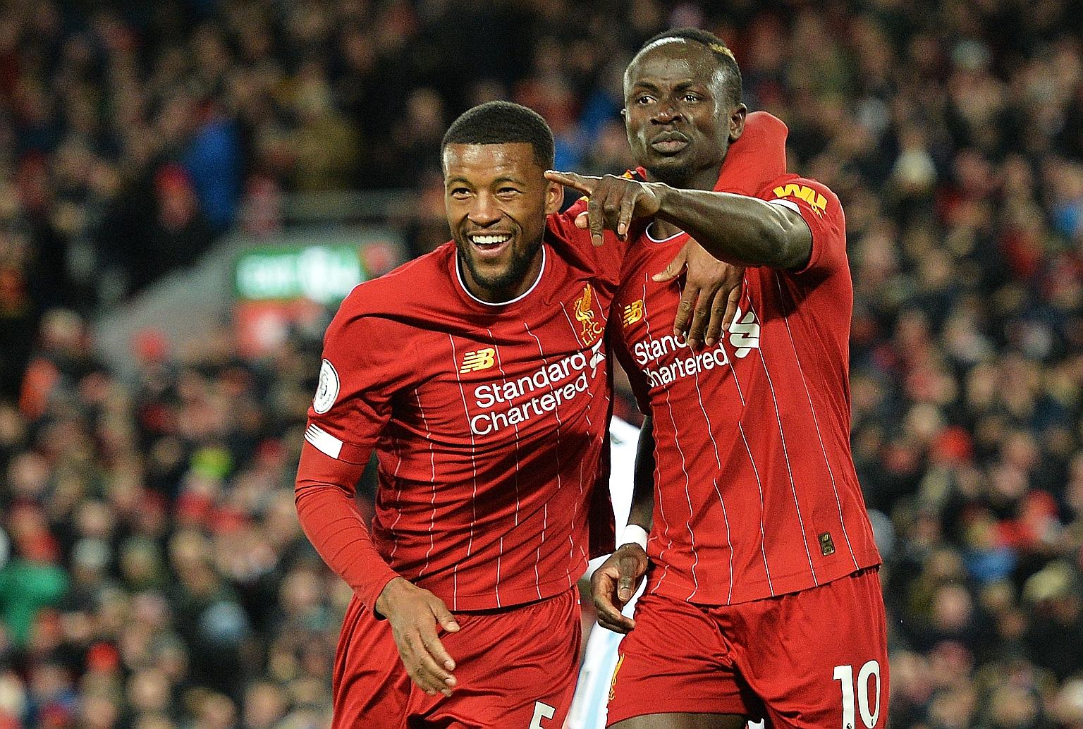Sadio Mane celebrating with teammate Georginio Wijnaldum (far left) after netting an effort against West Ham in the 86th minute. The goal was disallowed for offside but his 81st-minute winner sealed Liverpool's 18th straight Premier League victory. P