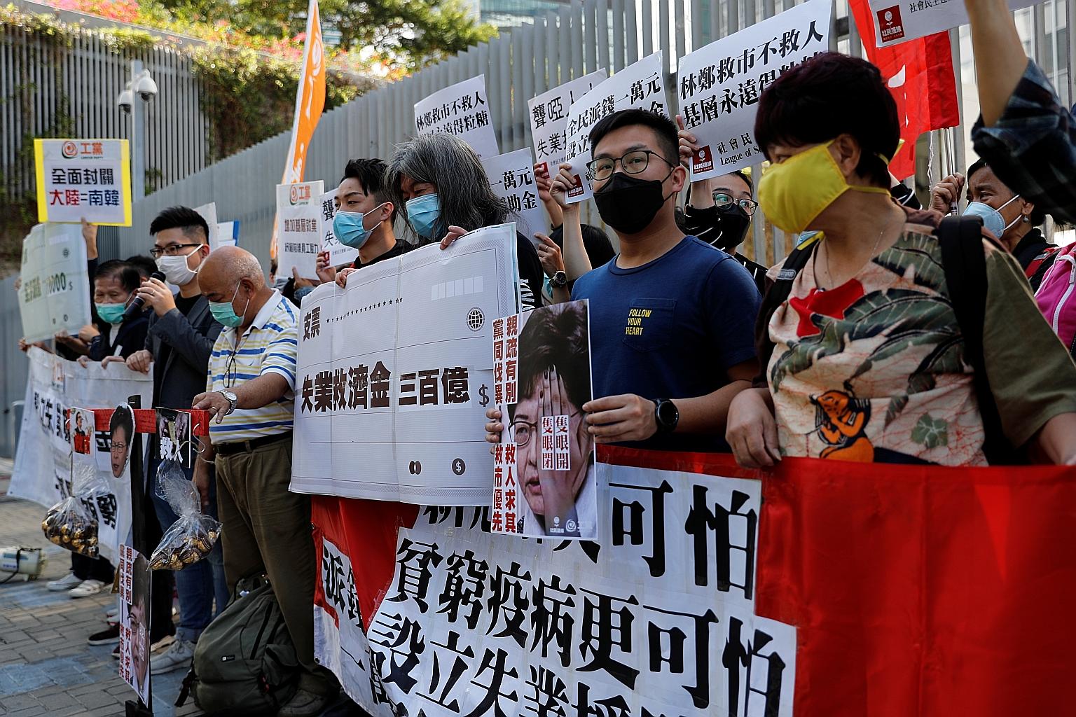 Protesters shouting slogans outside the Legislative Council in Hong Kong yesterday ahead of the budget announcement.