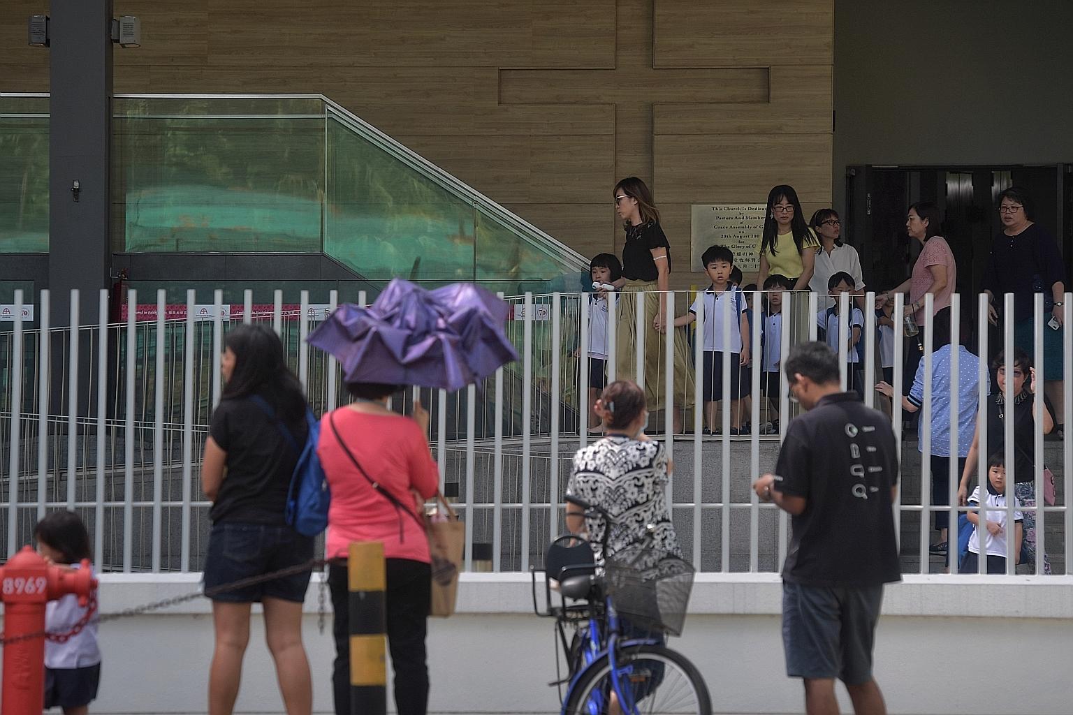 Parents waiting to pick up their children from Grace House Kindergarten at the Grace Assembly of God church site in Bukit Batok West after it resumed operations yesterday. Church services are expected to resume from this Saturday. ST PHOTO: KUA CHEE