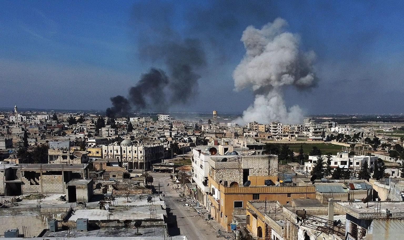 Smoke billowing over the town of Saraqib in Idlib province in north-western Syria on Thursday. At least 33 soldiers were killed in an air strike on Turkish forces in the province that day.