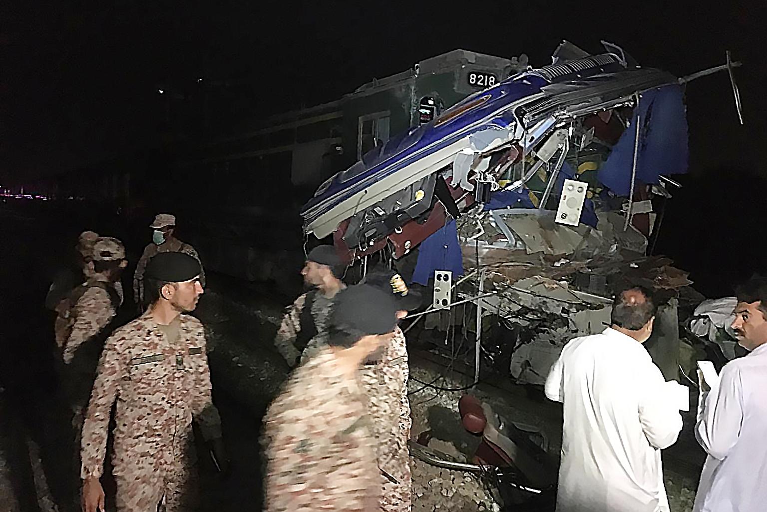 The site of the accident in Sukkur district in Pakistan's southern Sindh province on Friday. An incoming Pakistan Express, which was on its way from Karachi to Lahore, hit a bus that was heading to Sargodha in central Punjab province. At least 18 peo
