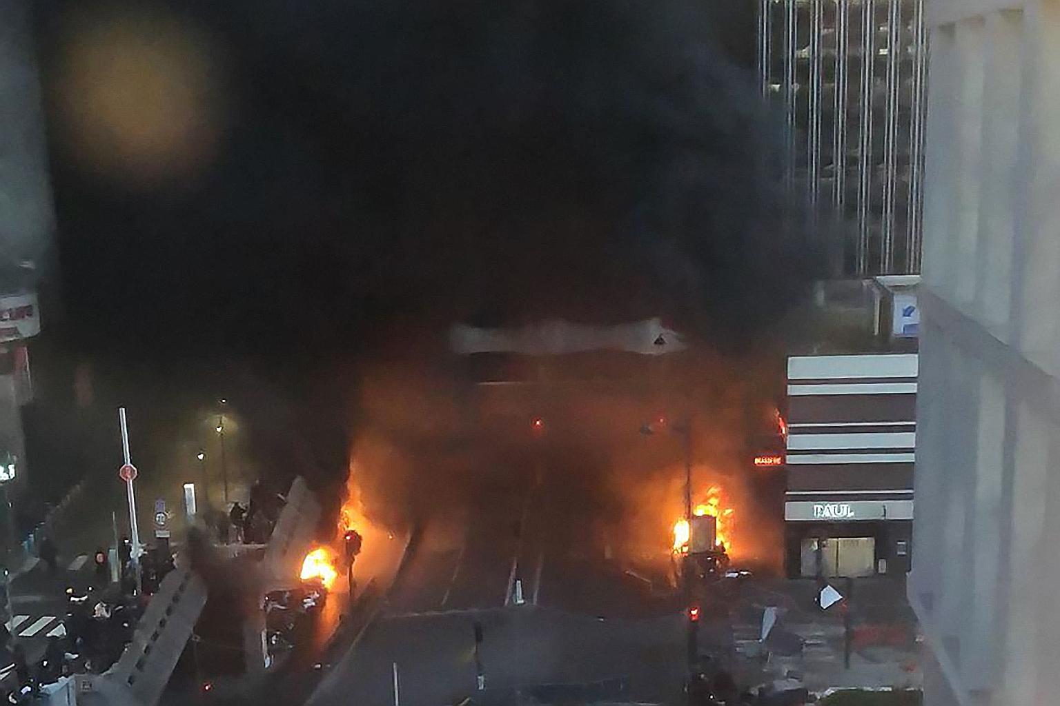 Vehicles and bins burning on the street in Paris on Friday. Dozens were arrested over their protest outside a concert venue hosting a Congolese singer they accuse of giving a voice to the Kinshasa regime.