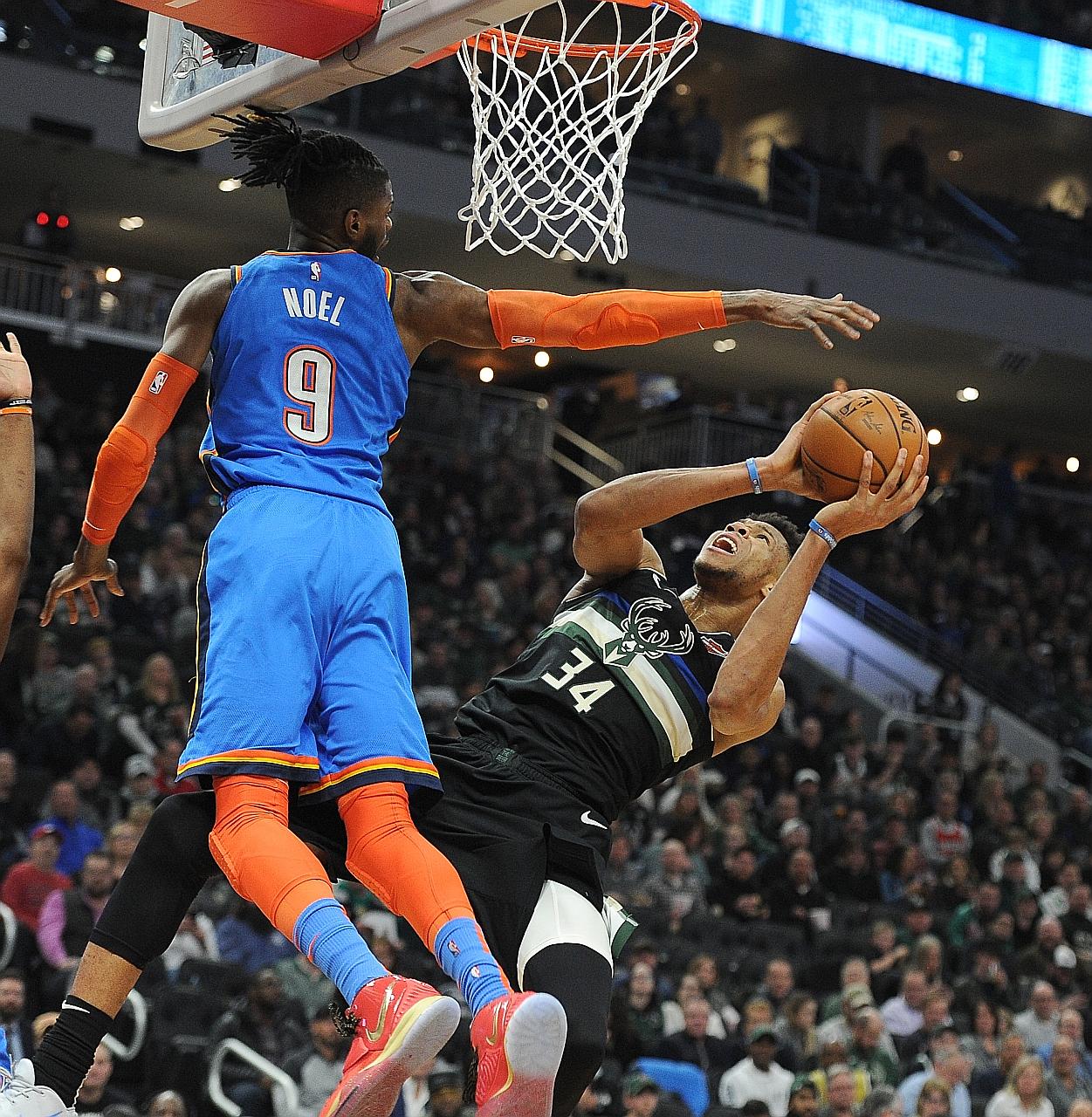 Bucks forward Giannis Antetokounmpo getting in a shot against Thunder centre Nerlens Noel despite losing his balance at Fiserv Forum in Milwaukee. The hosts' 133-86 rout is the second-biggest winning margin in an NBA game this season. PHOTO: REUTERS