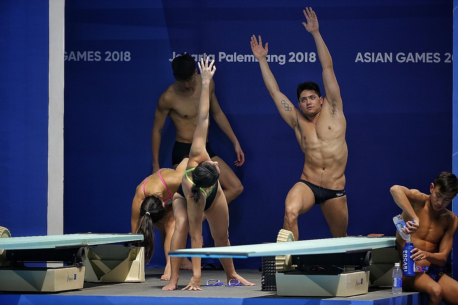 Singapore's Olympic champion Joseph Schooling stretching with teammates at training during the 2018 Asian Games in Indonesia. Dr Polly McGuigan from the University of Bath recommends around 30 seconds for a good static stretch. ST FILE PHOTO