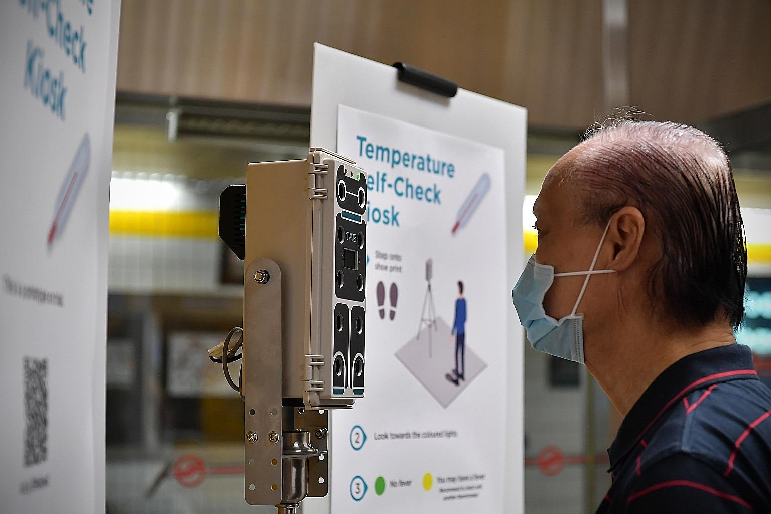 Mr Lim Shaw Leng, 78, checking his temperature at a prototype kiosk at Toa Payoh MRT station yesterday. It is part of an initiative to encourage people to check their temperature regularly amid the coronavirus outbreak. ST PHOTO: NG SOR LUAN