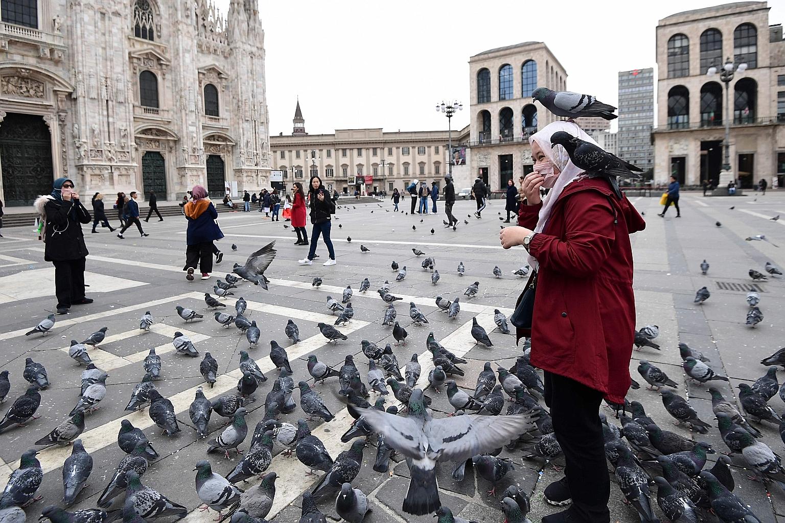 Tourists at the Piazza del Duomo in Milan, in Italy's northern Lombardy region, on Saturday. On Feb 21, Lombardy announced that a 38-year-old Italian man had tested positive for the virus. Within a week, 888 people were confirmed to have caught the d